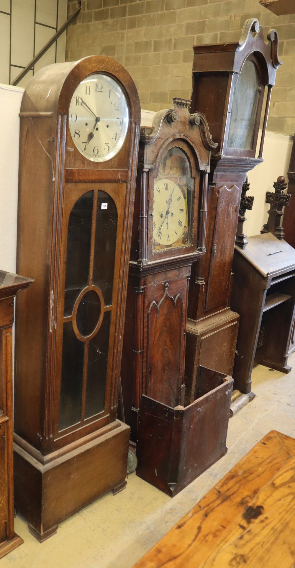 A George III mahogany longcase clock, a George III oak longcase clock case and a 1920s oak longcase clock